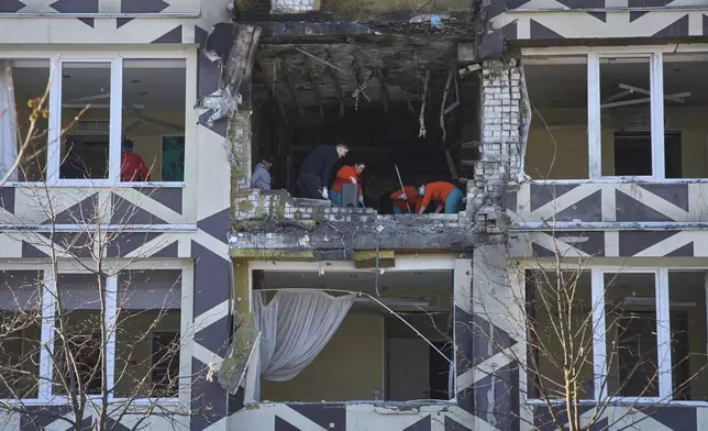Medical workers remove the debris in a damaged private clinic after, according to Ukrainian officials, a Russian drone hit a hospital room killing a patient, in Kyiv, Ukraine, Monday, Jan 5, 2026. (AP Photo/Efrem Lukatsky)