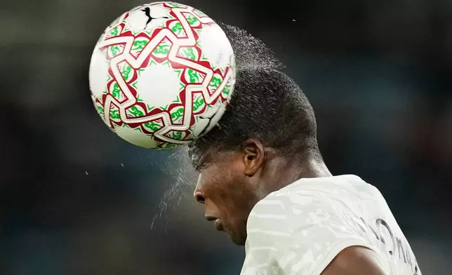 South Africa's Mbekezeli Mbokazi heads the wet ball during the Africa Cup of Nations round of 16 soccer match between South Africa and Cameroon in Rabat, Morocco, Sunday, Jan. 4, 2026. (AP Photo/Themba Hadebe)
