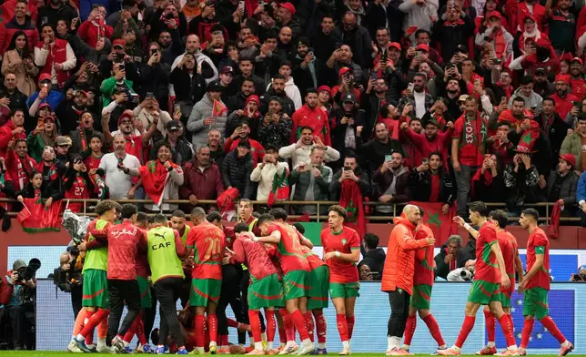 Moroccan players celebrate after teammate Brahim Abdelkader Diaz scored the opening goal during the Africa Cup of Nations round of 16 soccer match between Morocco and Tanzania in Rabat, Morocco, Sunday, Jan. 4, 2026. (AP Photo/Mosa'ab Elshamy)