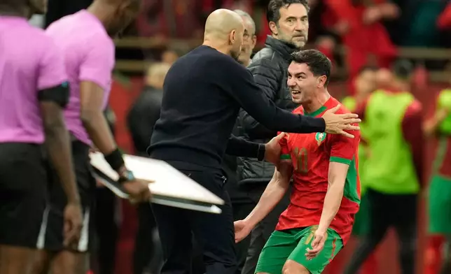 Morocco's Brahim Abdelkader Diaz celebrates with head coach Walid Regragui after scoring the opening goal during the Africa Cup of Nations round of 16 soccer match between Morocco and Tanzania in Rabat, Morocco, Sunday, Jan. 4, 2026. (AP Photo/Mosa'ab Elshamy)