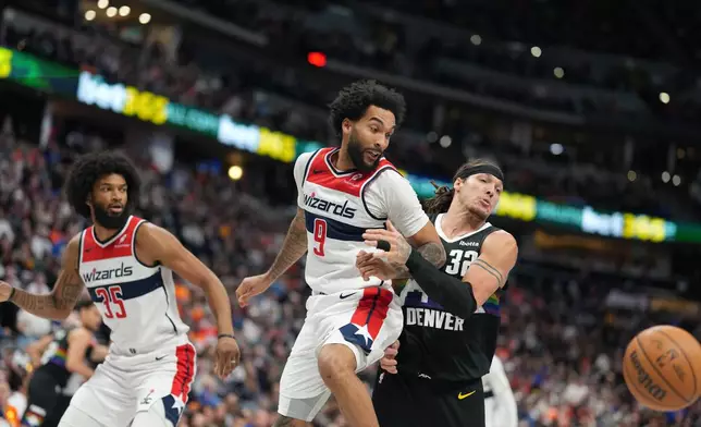 Denver Nuggets forward Aaron Gordon, right, pursues the ball with Washington Wizards guard Justin Champagnie, center, and forward Marvin Bagley III, left, in the second half of an NBA basketball game Saturday, Jan. 17, 2026, in Denver. (AP Photo/David Zalubowski)