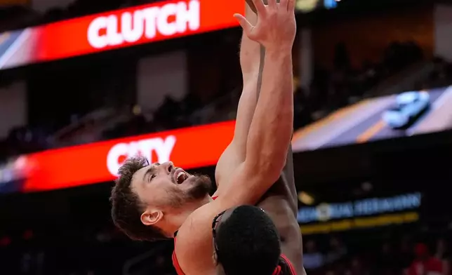 Houston Rockets center Alperen Sengun (28) shoots against Chicago Bulls forward Jalen Smith (25) during the first half of an NBA basketball game in Houston, Tuesday, Jan. 13, 2026. (AP Photo/Ashley Landis)