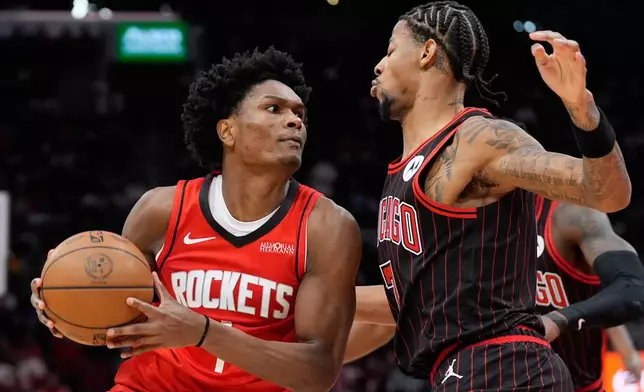 Chicago Bulls forward Dalen Terry (7) defends against Houston Rockets guard Amen Thompson (1) during the first half of an NBA basketball game in Houston, Tuesday, Jan. 13, 2026. (AP Photo/Ashley Landis)