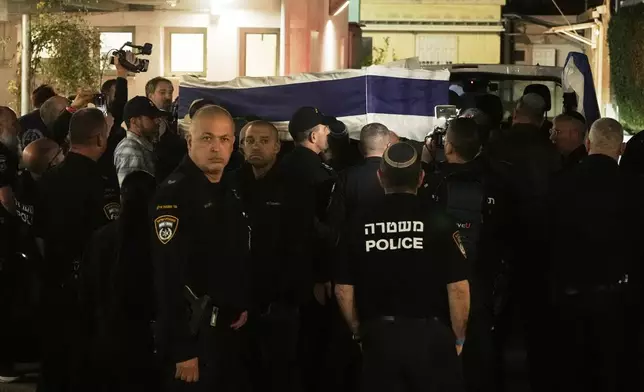 The coffin with remains of Israeli hostage Ran Gvili, last to be recovered from Gaza, arrives to the Abu Kabir Forensic Institute in Tel Aviv, Israel, Monday, Jan. 26, 2026. (AP Photo/Mahmoud Illean)