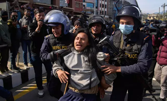 Nepalese police detain a young protester during an anti-government rally in Kathmandu, Nepal, on Dec. 22, 2025. (AP Photo/Niranjan Shrestha)