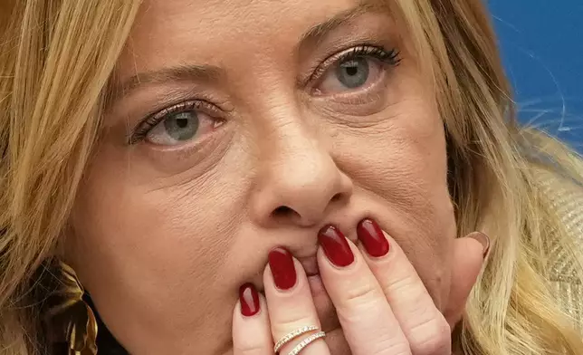 Italian Prime Minister Giorgia Meloni listens to a journalist's question during her annual start-of-the-year press conference in the press room at the Lower Chamber, in Rome, Friday, Jan. 9, 2026. (AP Photo/Andrew Medichini)