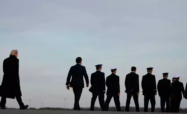 FILE - President Donald Trump arrives with his Defense Secretary Pete Hegseth and Chairman of the Joint Chiefs Air Force Gen. Dan Caine to Dover Air Force Base in Delaware, Dec. 17, 2025, for the casualty return of Iowa National Guard soldiers Sgt. William Nathaniel Howard, 29, of Marshalltown, Iowa, and Sgt. Edgar Brian Torres-Tovar, 25, of Des Moines, Iowa, and civilian interpreter Ayad Mansoor Sakat, who were killed in an attack in Syria. (AP Photo/Julia Demaree Nikhinson, File)