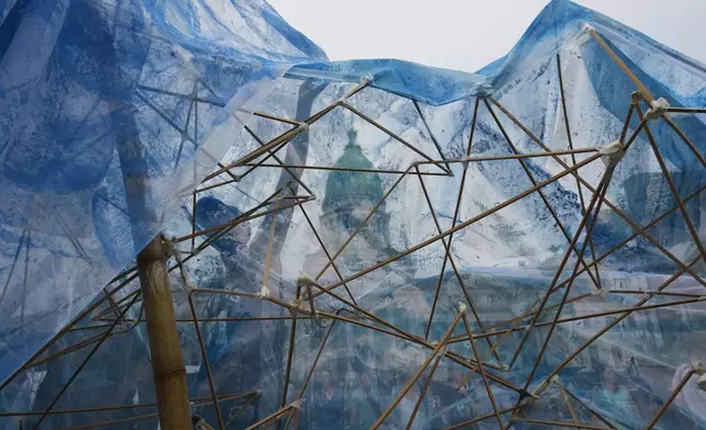FILE - Environmentalists create a glacier-shaped structure outside Congress in Buenos Aires, Argentina, to protest a bill that would ease environmental protections, Dec. 22, 2025. (AP Photo/Rodrigo Abd, File)
