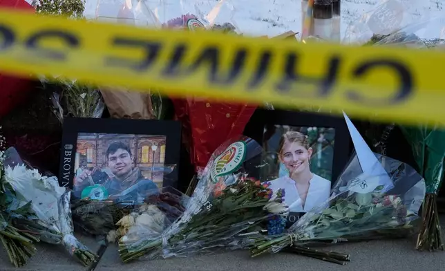 FILE - Photos of Brown University shooting victims MukhammadAziz Umurzokov, left, and Ella Cook, lay on a makeshift memorial outside the Engineering Research Center, Dec. 16, 2025, in Providence, R.I. (AP Photo/Robert F. Bukaty, File)