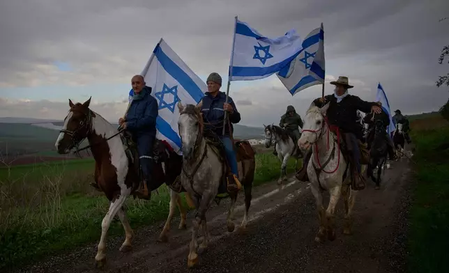 FILE - Israelis ride on horseback for the funeral procession of Aviv Maor, an 18-year-old Israeli who was killed by a Palestinian attacker the previous week, at Kibbutz Ein Harod cemetery in northern Israel, Dec. 29, 2025. (AP Photo/Ohad Zwigenberg, File)