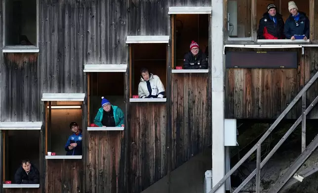 FILE - Judges in their windows watch the men's Individual Gundersen Normal Hill/10Km event at the Nordic Combined World Cup in Ramsau am Dachstein, Austria, Dec. 20, 2025. (AP Photo/Matthias Schrader, File)