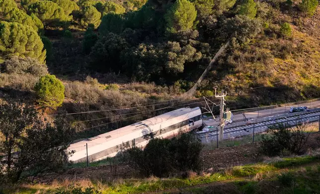 Part of a wrecked train is photographed at the site of a train collision in Adamuz, southern Spain, Monday, Jan. 19, 2026. (AP Photo/Manu Fernandez)