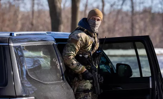 A U.S. Border Patrol officer steps out of his vehicle after blocking a street in Minneapolis, Wednesday, Jan. 14, 2026. (AP Photo/Adam Gray)