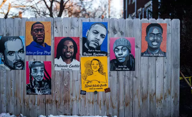 A poster depicting Renee Good, who was fatally shot by an ICE officer last week, is displayed on a fence alongside other people who were killed by police, in Minneapolis, Wednesday, Jan. 14, 2026. (AP Photo/Adam Gray)