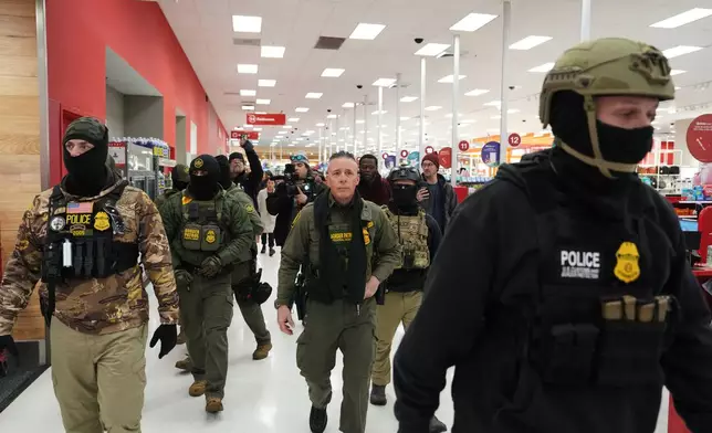 U.S. Border Patrol Cmdr. Gregory Bovino walks through a Target store Sunday, Jan. 11, 2026, in St. Paul, Minn. (AP Photo/Adam Gray)