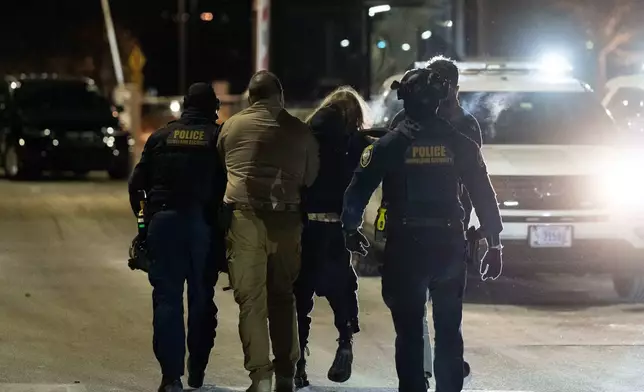 Federal immigration officers detain a protestor outside Bishop Henry Whipple Federal Building, Thursday, Jan. 15, 2026, in Minneapolis. (AP Photo/Adam Gray)