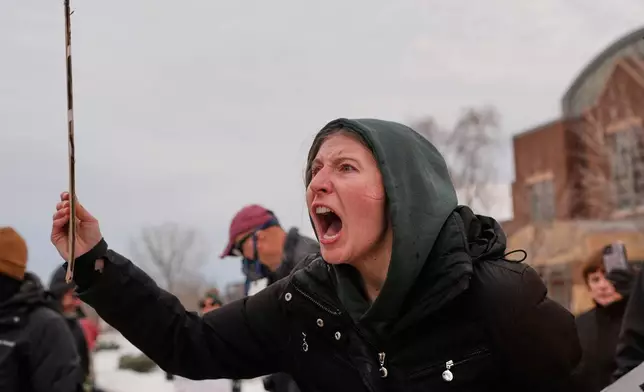 A protester shouts at federal immigration officers Sunday, Jan. 11, 2026, in Minneapolis. (AP Photo/Jen Golbeck)
