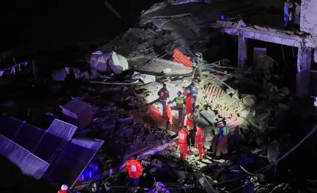 Rescue workers search for possible victims in a building destroyed by an Israeli airstrike in the southern port city of Sidon, Lebanon, early Tuesday, Jan. 6, 2026. (AP Photo/Mohammed Zaatari)