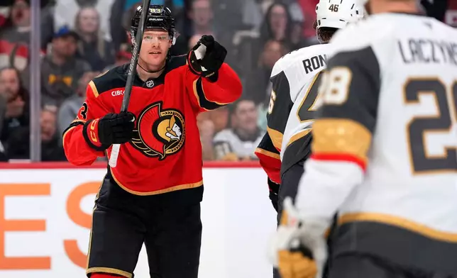 Ottawa Senators' Stephen Halliday, left, points toward teammate Tim Stutzle (not shown), who earned an assist, as he celebrates after scoring against the Vegas Golden Knights during second-period NHL hockey game action in Ottawa, Ontario, Sunday, Jan. 25, 2026. (Justin Tang/The Canadian Press via AP)