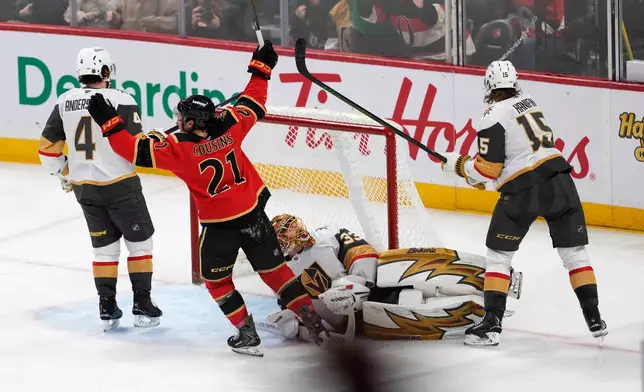 Ottawa Senators' Nick Cousins (21) celebrates after a goal teammate Nick Jensen (not shown) as Vegas Golden Knights goaltender Adin Hill (33) lies on the ice during third-period NHL hockey game action in Ottawa, Ontario, Sunday, Jan. 25, 2026. (Justin Tang/The Canadian Press via AP)