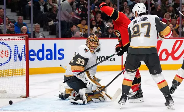 Ottawa Senators' Brady Tkachuk (7) reacts as the shot of Jordan Spence (10), not shown, goes in the net past Vegas Golden Knights goaltender Adin Hill (33) during the second period of an NHL hockey game in Ottawa, Sunday, Jan. 25, 2026. (Justin Tang/The Canadian Press via AP)
