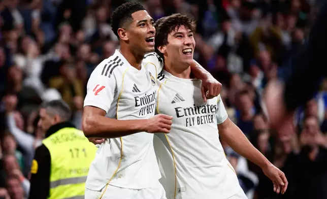 Real Madrid's Gonzalo Garcia, right, celebrates with Real Madrid's Jude Bellingham after scoring his sides first goal during the Spanish La Liga soccer match between Real Madrid and Real Betis Sevilla in Madrid, Spain, Sunday, Jan. 4, 2026. (AP Photo/Pablo Garcia)