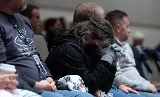 People attend the National Transportation Safety Board (NTSB) hearing on the midair aircraft collision that killed 67 people near Washington Reagan National Airport, in Washington, Tuesday, Jan. 27, 2026. (AP Photo/Jose Luis Magana)