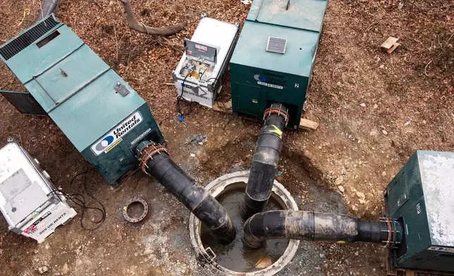 Interceptor pipes inserted into raw sewage after a massive pipe rupture has sent sewage spilling into the Potomac River, in Glen Echo, Md., Friday, Jan. 23, 2026. (AP Photo/Cliff Owen)
