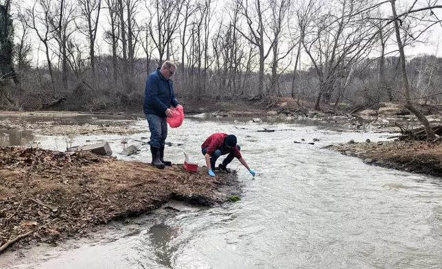 Water samples are taken from the Potomac River, Friday, Jan. 23, 2026 in Glen Echo, Md. A massive pipe that moves millions of gallons of sewage has ruptured and sent wastewater flowing into the Potomac River northwest of Washington, polluting it ahead of a major winter storm that has repair crews scrambling. (AP Photo/Nathan Ellgren)