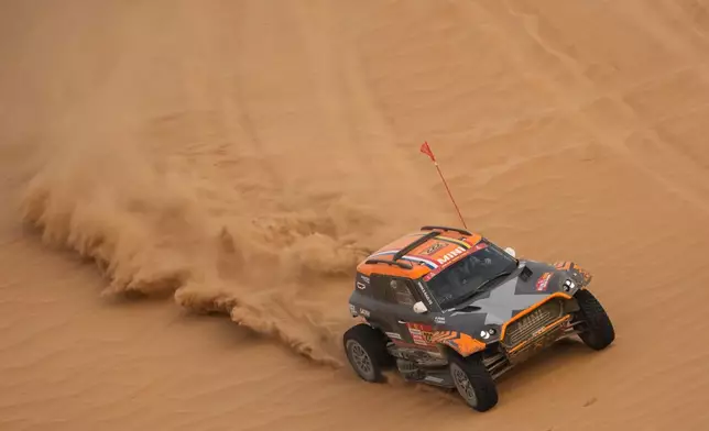 Driver Guillaume de Mevius and co-driver Mathieu Baumel compete during the tenth stage of the Dakar Rally between Wadi Ad Dawasir and Bisha, Saudi Arabia, Wednesday, Jan.14, 2026. (AP Photo/Thibault Camus)