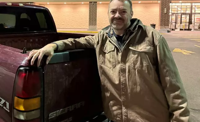 Travis Garcia, a 45-year-old supporter of President Donald Trump, poses for a picture as he leans against his pickup truck in Castle Rock, Colo., Jan. 5, 2026. (AP Photo/Jesse Bedayn)