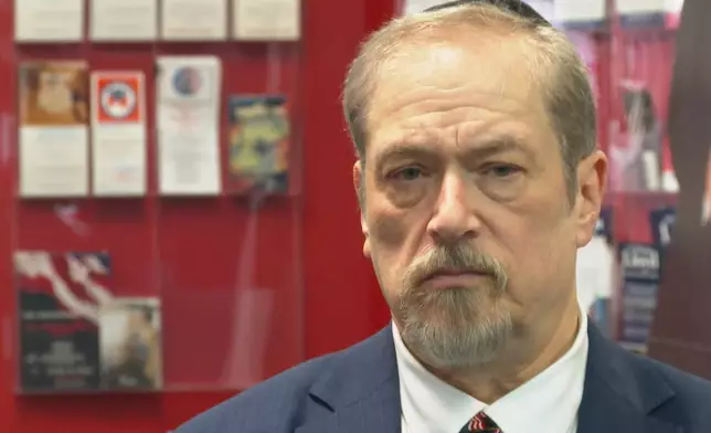 Aaron Tobin, a supporter of President Donald Trump, listens to a question during an interview, Jan. 5, 2026, in Bloomfield Hills, Mich. (AP Photo/Mike Householder)