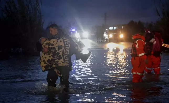 Local people are rescued by the civil emergency after flooding in Ferras, Fier, Albania. Thursday, Jan 8, 2026. (AP Photo/Hameraldi Agolli)