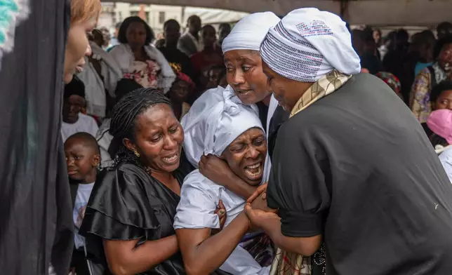 The families of victims mourn at the funeral service for civilians killed in a drone strike in Goma, Democratic Republic of Congo, Thursday, Jan. 8, 2026. (AP Photo/Moses Sawasawa)