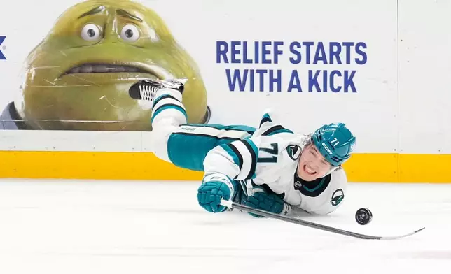San Jose Sharks center MacKlin Celebrini falls while reaching for the puck during the first period of an NHL hockey game against the Los Angeles Kings, Wednesday, Jan. 7, 2026, in Los Angeles. (AP Photo/Mark J. Terrill)