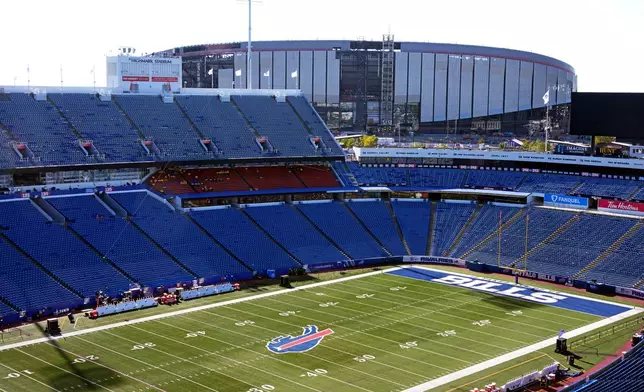 FILE - The Highmark Stadium, foreground, frames the construction on the new Highmark Stadium, upper right, scheduled to open with the 2026 season, shown before an NFL football game between the Buffalo Bills and the New England Patriots, Oct. 5, 2025, in Orchard Park, N.Y. (AP Photo/Gene J. Puskar, File)