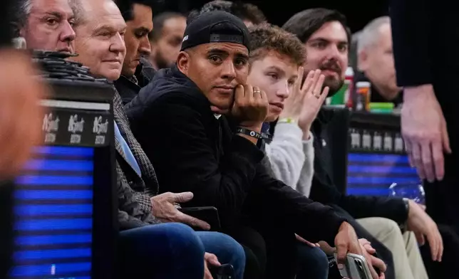 Boston Red Sox pitcher Ranger Suarez, center, sits courtside during the second half of an NBA basketball game between the Boston Celtics and Indiana Pacers, Wednesday, Jan. 21, 2026, in Boston. (AP Photo/Charles Krupa)