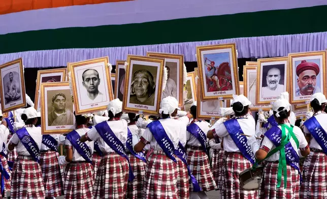 Schoolgirls walk with portraits of Indian freedom fighters and eminent personalities during a Republic Day ceremonial parade, in Kolkata, India, Monday, Jan. 26, 2026. (AP Photo/Bikas Das)