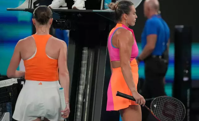 Aryna Sabalenka, right, of Belarus walks past Elina Svitolina of Ukraine during their semifinal match at the Australian Open tennis championship in Melbourne, Australia, Thursday, Jan. 29, 2026. (AP Photo/Dita Alangkara)