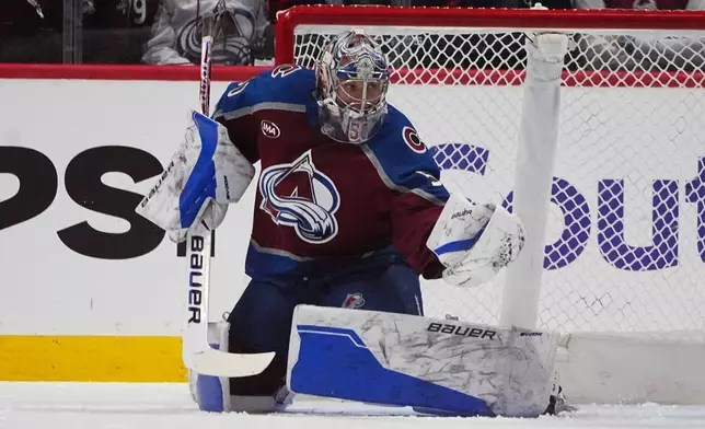 Colorado Avalanche goaltender Trent Miner makes a glove save in the first period of an NHL hockey game against the Columbus Blue Jackets Saturday, Jan. 10, 2026, in Denver. (AP Photo/David Zalubowski)