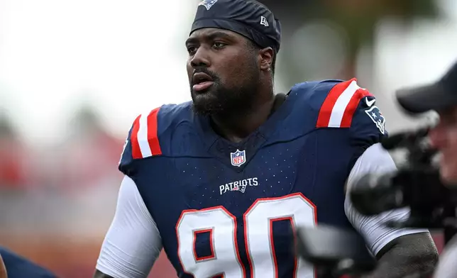 FILE - New England Patriots defensive tackle Christian Barmore (90) warms up before an NFL football game against the Tampa Bay Buccaneers, Sunday, Nov. 9, 2025, in Tampa, Fla. (AP Photo/Phelan M. Ebenhack, File)