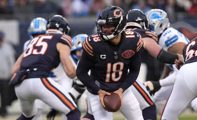 Chicago Bears quarterback Caleb Williams (18) looks to hand the ball off during the first half of an NFL football game against the Detroit Lions, Sunday, Jan. 4, 2026, in Chicago. (AP Photo/Nam Y. Huh)