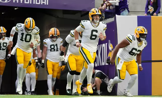 Green Bay Packers quarterback Clayton Tune (6) leads teammates onto the field before an NFL football game against the Minnesota Vikings, Sunday, Jan. 4, 2026, in Minneapolis. (AP Photo/Ross D. Franklin)