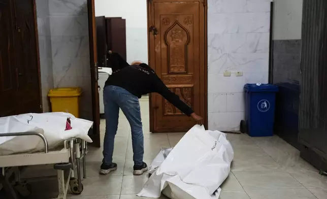 The bodies of Palestinians killed in an Israeli army strike are brought to the morgue at Nasser Hospital in Khan Younis, in the Gaza Strip, Thursday, Jan. 8, 2026. (AP Photo/Abdel Kareem Hana)
