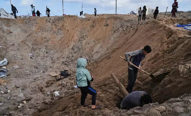 Palestinians inspect the damage at a displacement camp following an Israeli strike in Gaza City, Friday, Jan. 9, 2026. (AP Photo/Jehad Alshrafi)
