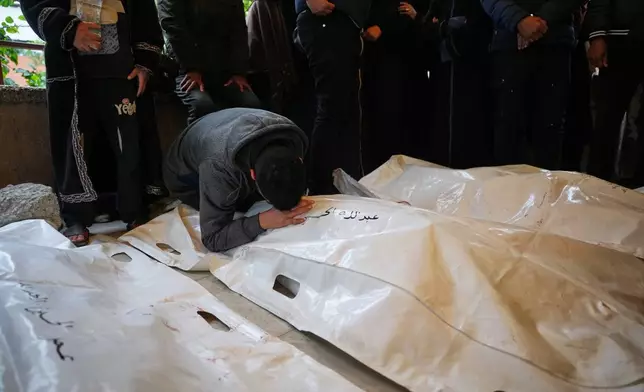 Palestinians attend the funeral of Abdullah Al-Abdullah, his brother Omar, and their aunt Lian Abu Shaqra at Nasser Hospital in Khan Younis, Gaza Strip, after they were killed in an Israeli military strike, Friday, Jan. 9, 2026.(AP Photo/Abdel Kareem Hana)