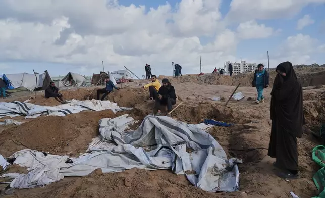 Palestinians inspect the damage at a displacement camp following an Israeli strike in Gaza City, Friday, Jan. 9, 2026. (AP Photo/Jehad Alshrafi)