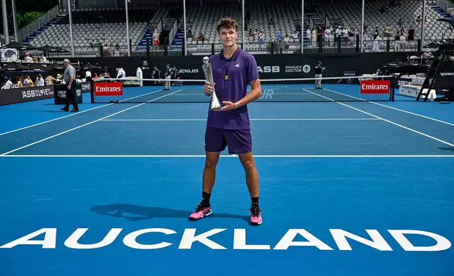 Jakub Mensik of the Czech Republic poses with his trophy after defeating Sebastian Baez of Argentina in the men's singles final of the ASB Classic in Auckland, New Zealand, Saturday, Jan. 17, 2026. (Alan Lee/ Photosport via AP)