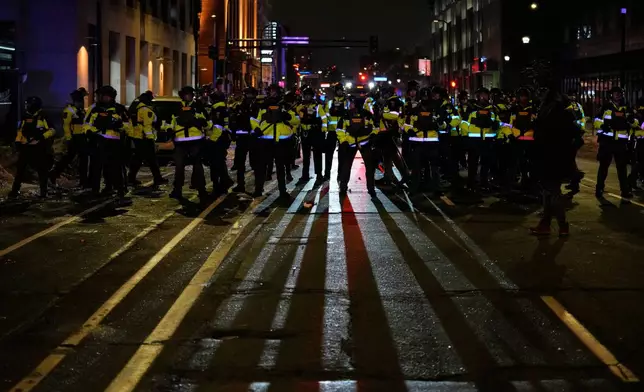 Minnesota State Patrol officers are seen during a protest and noise demonstration calling for an end to federal immigration enforcement operations in the city, Friday, Jan. 9, 2026, in Minneapolis. (AP Photo/John Locher)