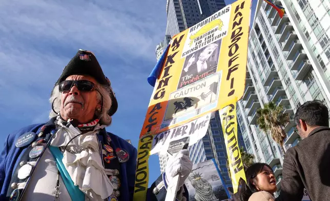 Protesters gather during a demonstration calling for an end to federal immigration enforcement operations and U.S. attacks on Venezuela, Saturday, Jan. 10, 2026, in Los Angeles. (AP Photo/Jill Connelly)